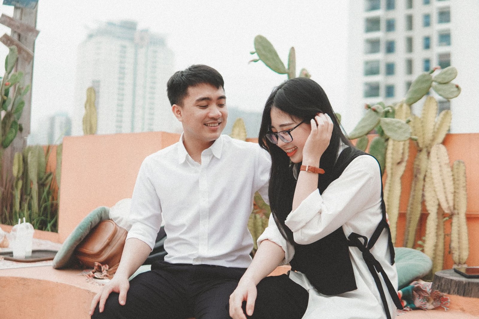 man in white long sleeve shirt sitting beside woman in white long sleeve shirt
