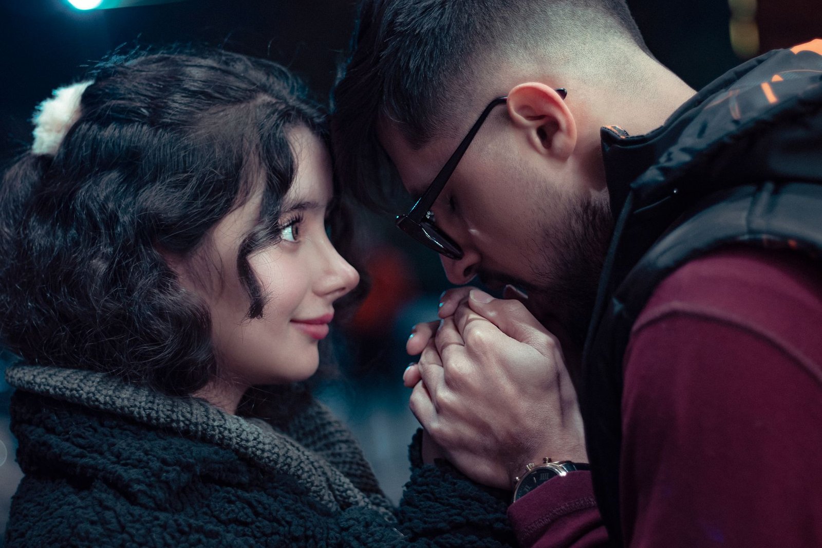 close up photo of man kissing the hands of a woman