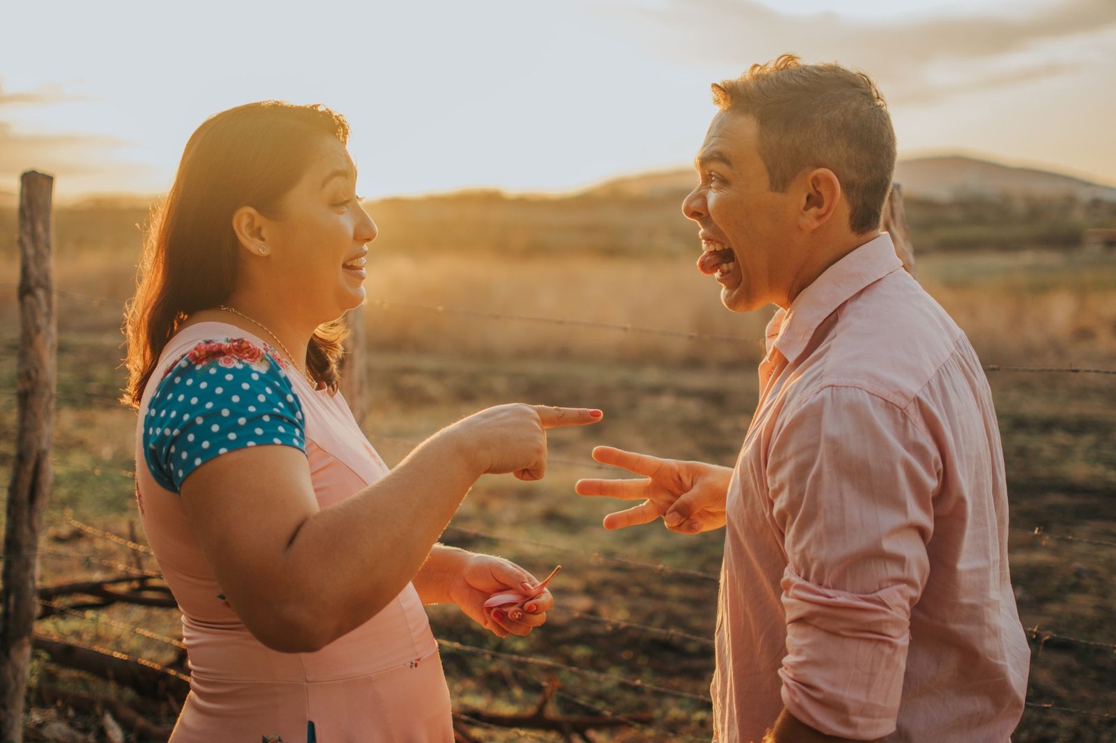 a man and woman are talking to each other in a field