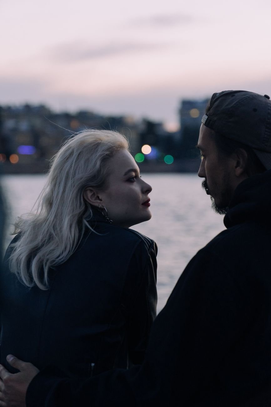 woman in black hoodie standing beside man in black hoodie