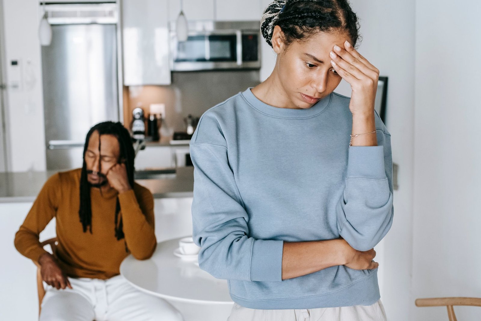 black couple arguing with each other in kitchen