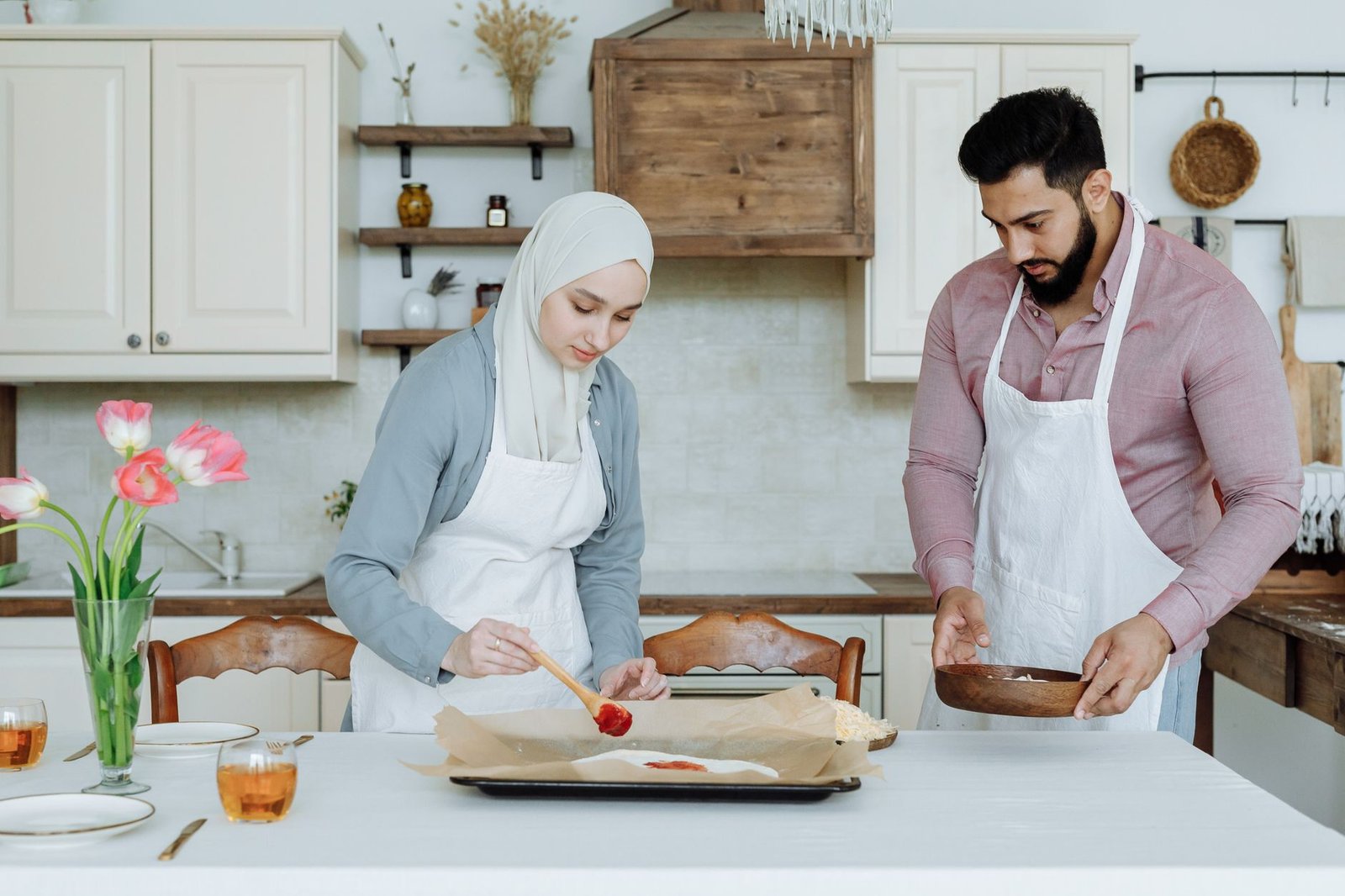 muslim couple preparing food in the kitchen