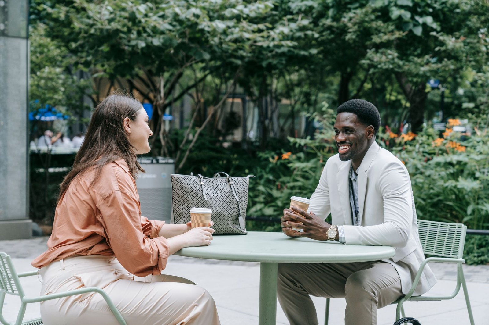 two people talking at a cafe table