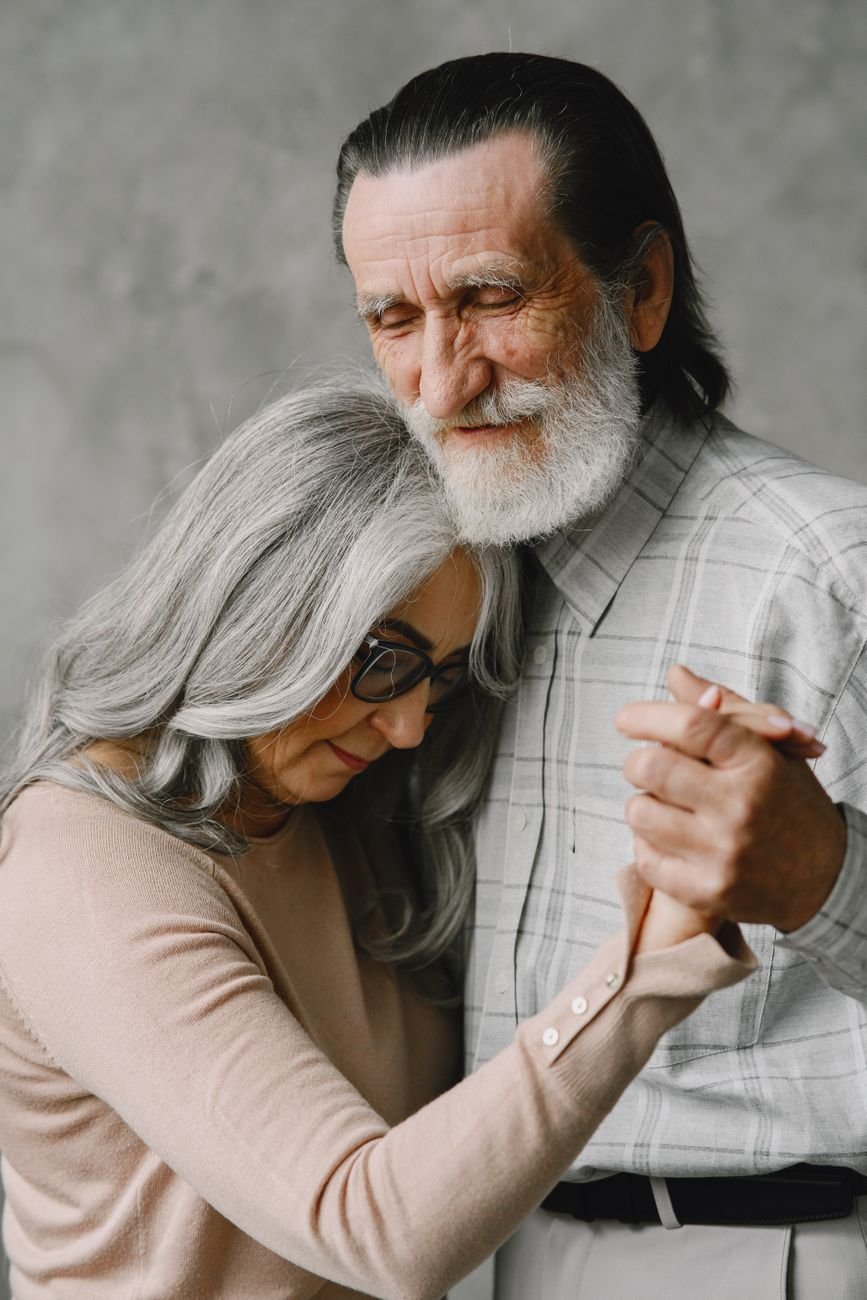 elderly couple dancing together