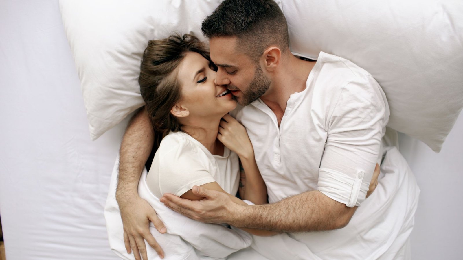 romantic couple embracing in bed