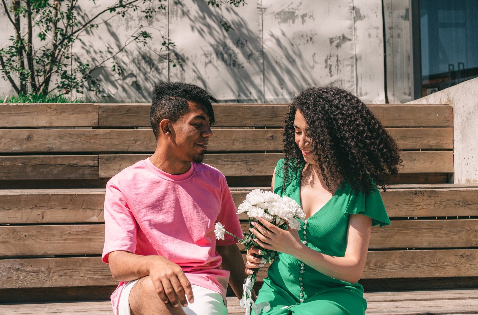 a man giving a woman a bouquet of flowers